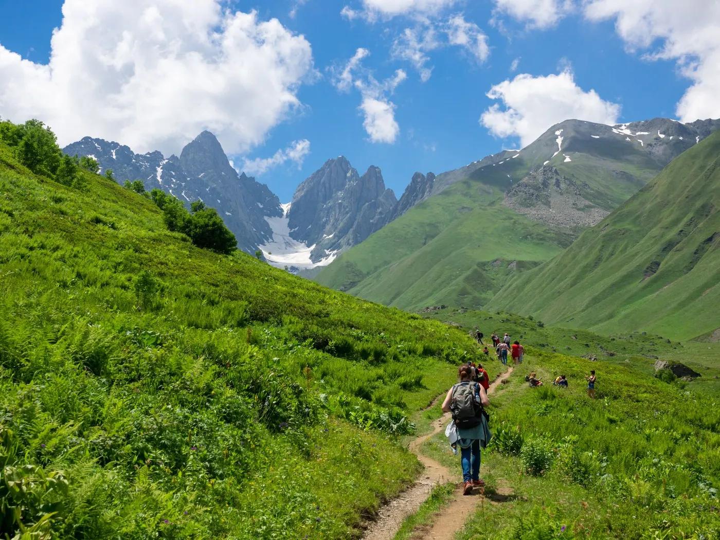 Hikers exploring a picturesque mountain trail in Mtskheta-Mtianeti, Georgia.