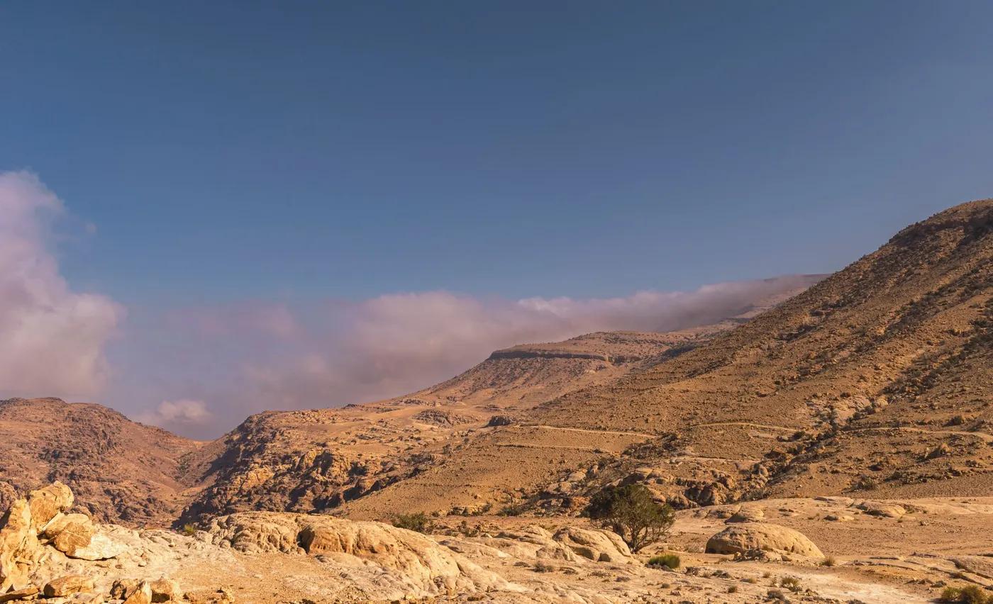 Explore the breathtaking arid landscape of Shobak, Jordan with stunning mountain views.