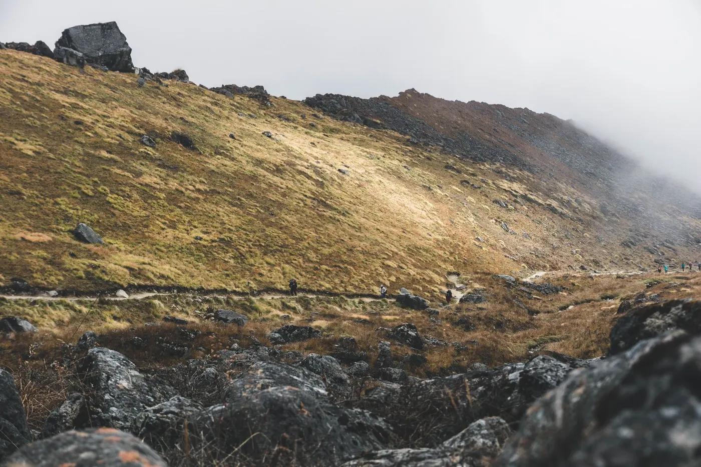 Foggy mountain landscape with a rocky trail in Annapurna, Nepal.