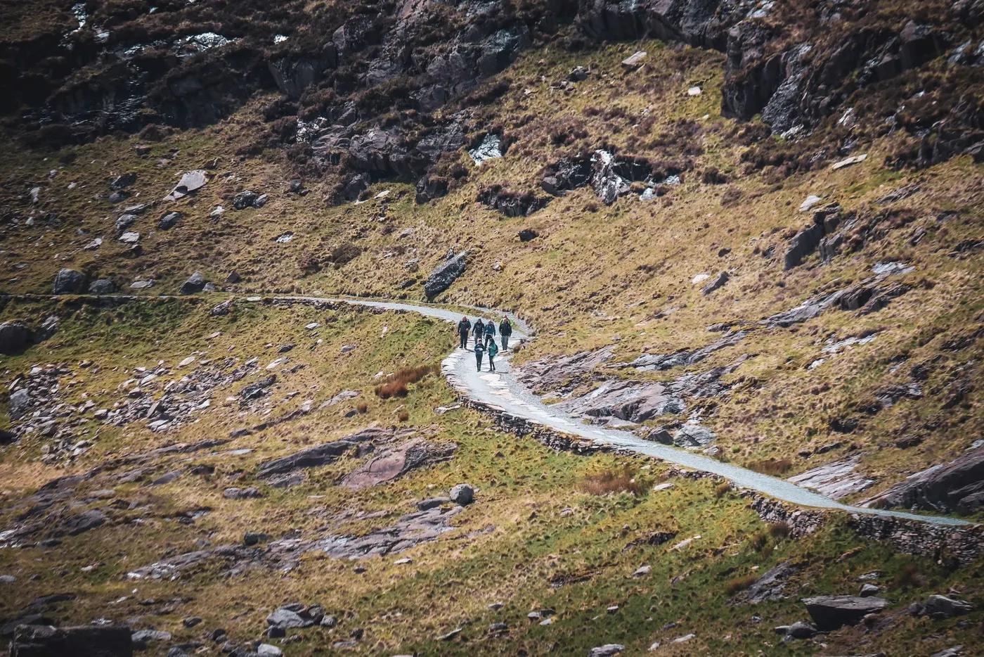 A group of hikers enjoying a scenic trail in the mountainous region of Wales, United Kingdom.