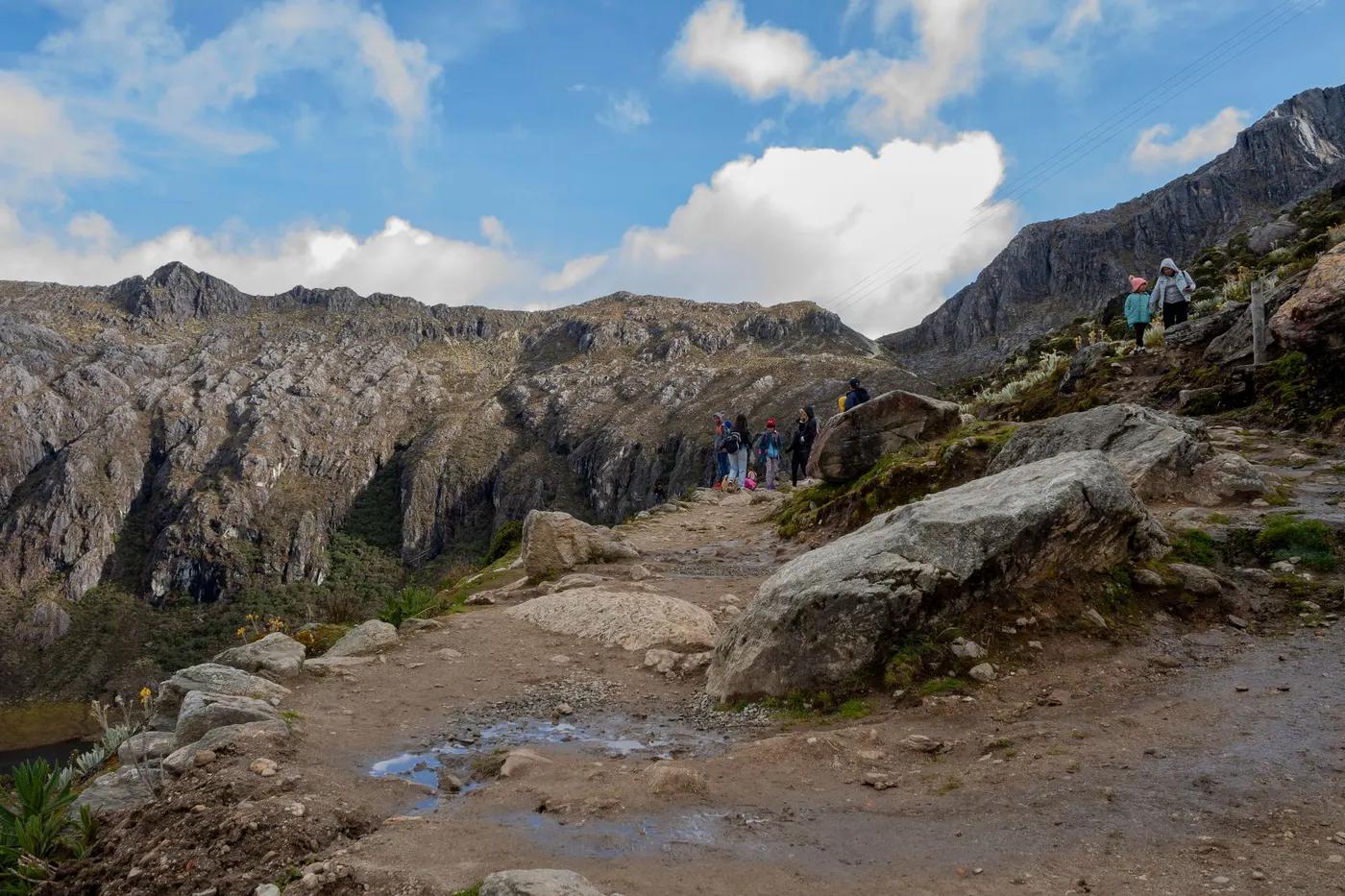 Explore the rugged beauty of Mérida's mountain range with hikers on a scenic trail.